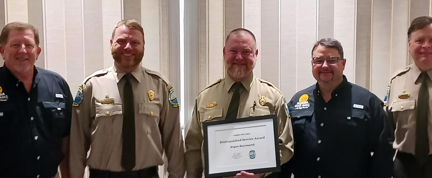 Bryan Kaczmarek receives an award from Chuck Hatcher, Billy Baily, Brian Fugate and Steve Cutshaw.